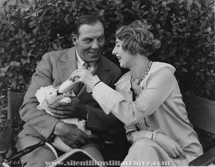 263-x-57 Karl Dane, Charlotte Greenwood and "Happy" the cat in the role of a baby, stage a tableau between scenes in Metro-Goldwyn-Mayer's "Baby Mine" (1928)