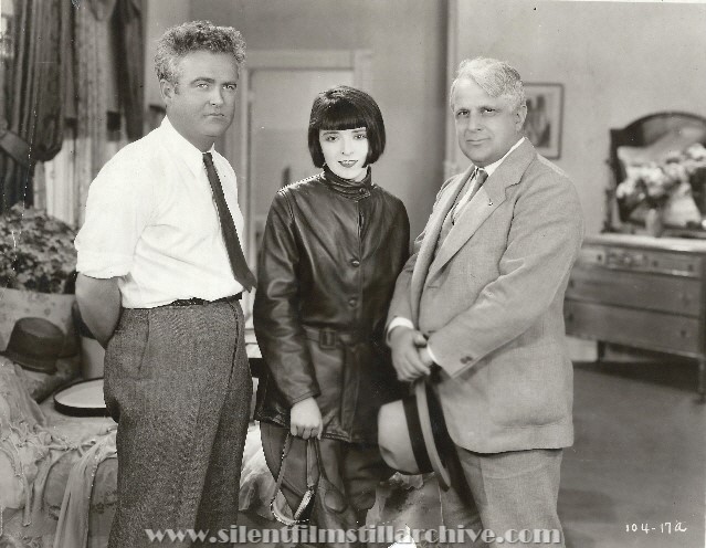 Director Marshall Neilan, actress Colleen Moore and Labor Secretary James J. Davis on the set of HER WILD OAT (1927).