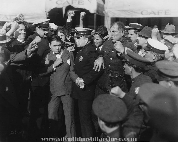 George K. Arthur and Karl Dane held apart by a policeman  in ROOKIES (1927)