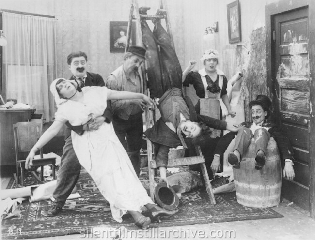 Marta Golden, Billy Armstrong, Charles Chaplin, Edna Purviance and Leo White in WORK (1915)