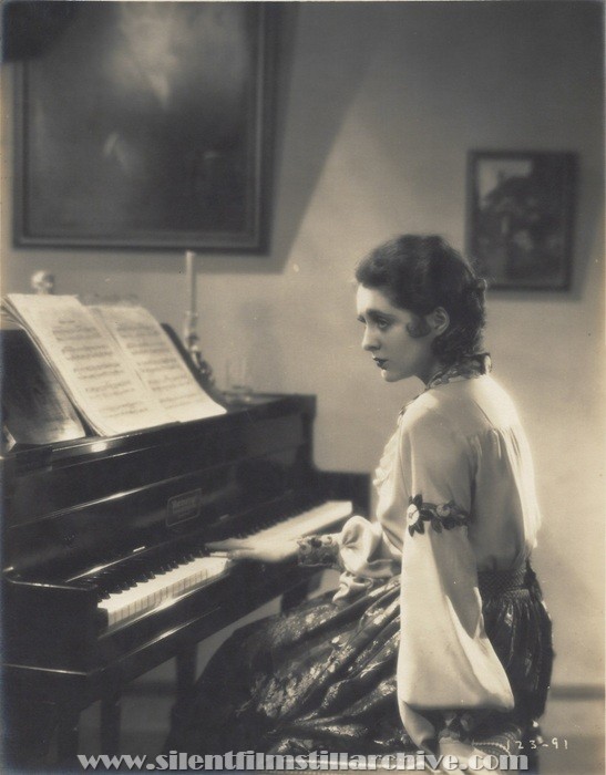 Billie Dove plays a piano in THE YELLOW LILY (1928)