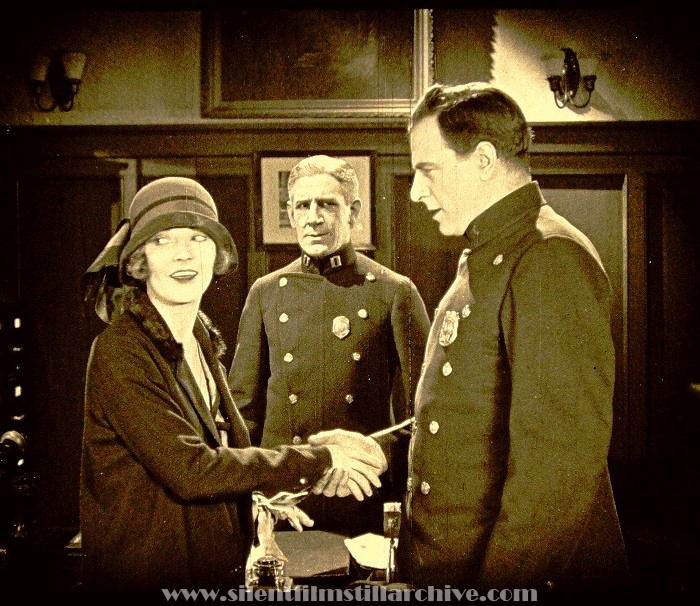 Frame enlargement from THE MAKING OF O'MALLEY (1925) with Dorothy Mackaill, Claude King, and Milton Sills.