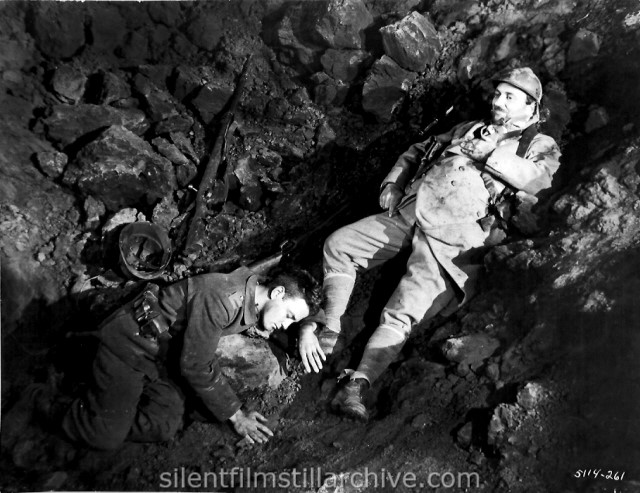 Lew Ayres and Raymond Griffith in ALL QUIET ON THE WESTERN FRONT (1931). Paul stabs the French soldier who falls into the shall-hole where he has taken cover.