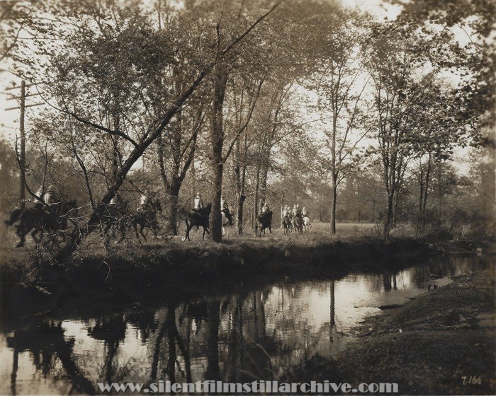 Soldiers ride ride horses in the forest in THE FIGHTING BLADE (1923)
