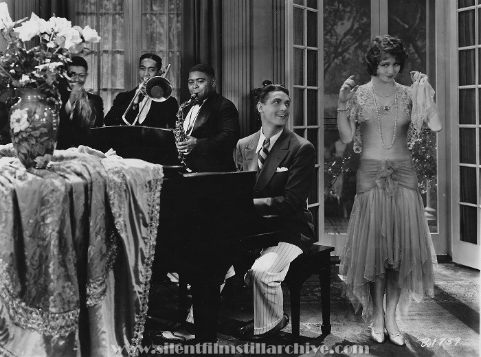 George Orendorff (trumpet), Lawrence Brown (trombone), Paul Howard (saxophone), Charles Farrell and Sharon Lynn in SUNNY SIDE UP (1929). The musicians are members of the band Paul Howard's Quality Serenaders.